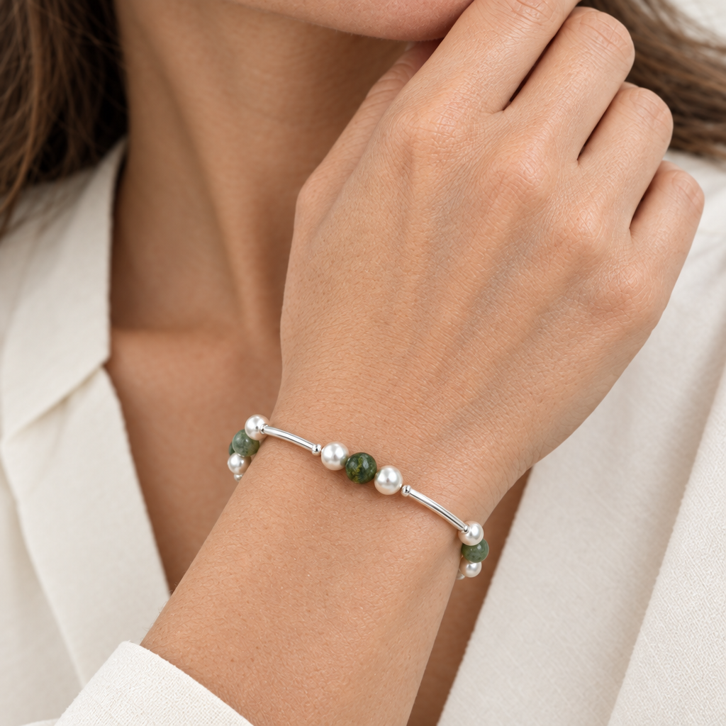 Close-up of the moss agate bracelet worn on a woman’s wrist