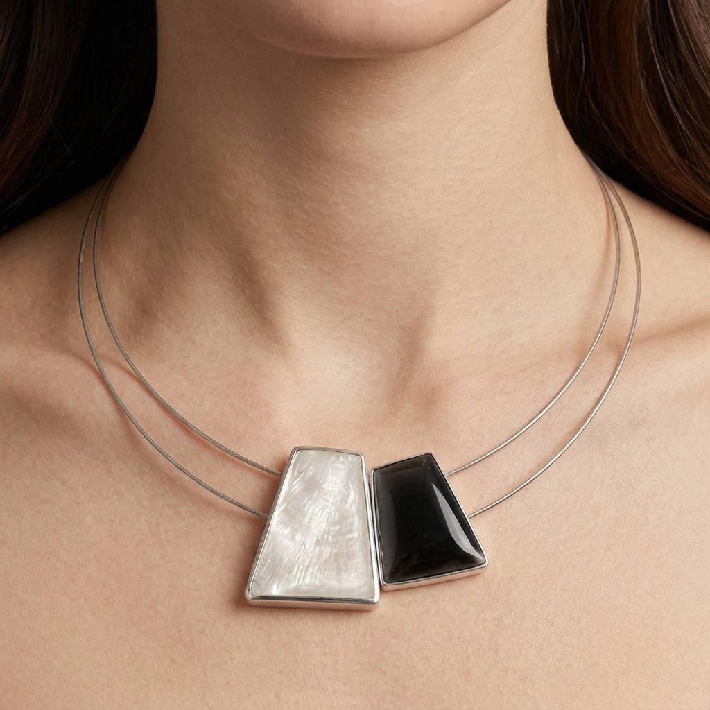 Close-up of the necklace resting on the model’s skin with a blue neckline