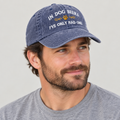 Man wearing the blue Dog Beers hat and looking to his left