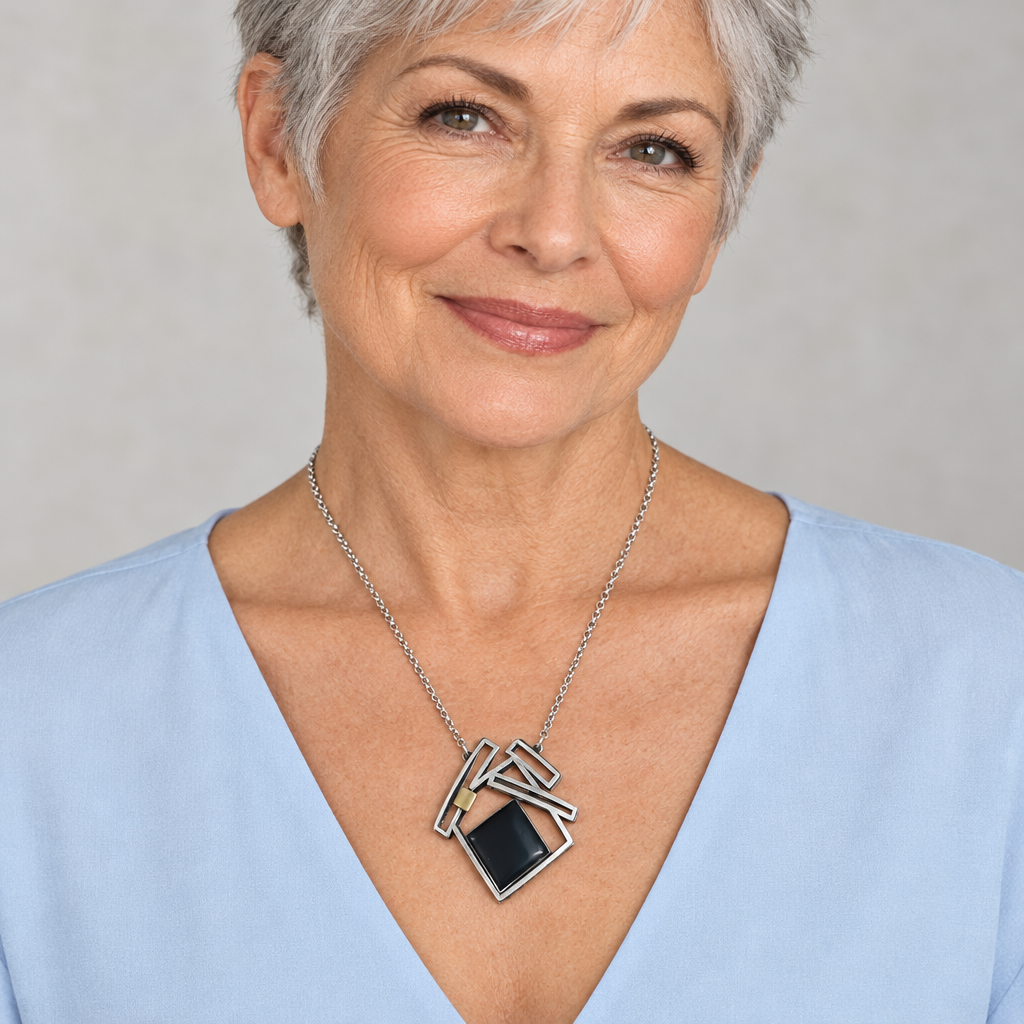 Older model with short silver hair wearing the Rectangles necklace