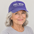 Older woman wearing the purple Dog Mom cap